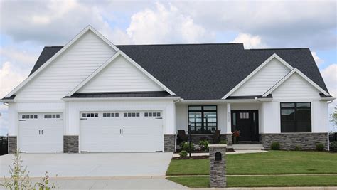 white house black trim metal roof|house with black metal roof.